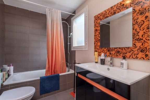 Guest bathroom remodeling with modern bathtub, vanity, shower, and decorative tile