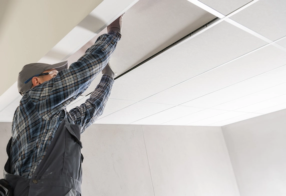 Kitchen with ceiling soffit above white cabinets