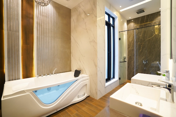 Walk-in tub installation in a modern bathroom with glass shower