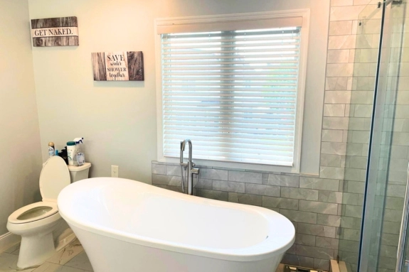 Bathroom remodel with freestanding bathtub and tiled walk-in shower in Levittown, PA