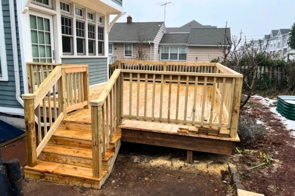 Wood deck with stairs and railing at a home in Bristol, PA