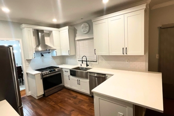 Modern kitchen with custom white cabinetry, island, and updated appliances in Willingboro, NJ