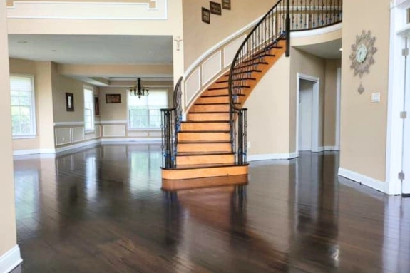 Wood flooring installed throughout a Burlington, NJ home with a curved staircase