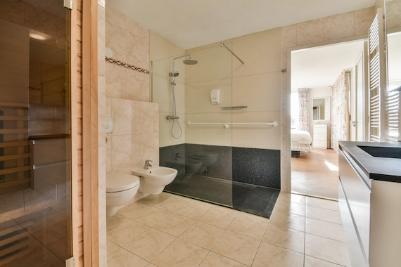 Bathrooms and walk-in showers featuring professional tile flooring installation.