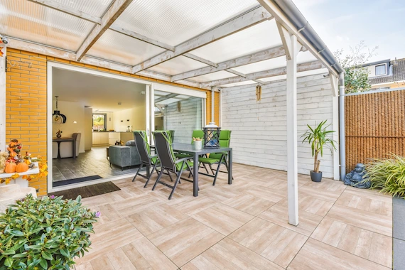 Outdoor patios and sunrooms featuring professional tile flooring installation and a covered seating area.